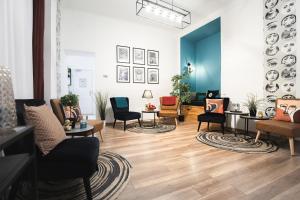 a waiting room with chairs and tables in a building at Maverick Hostel & Ensuites in Budapest