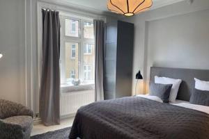 Un dormitorio con una cama grande y una ventana en 2 Bedroom Flat in Trendy Area en Copenhague