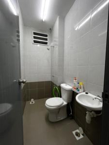a bathroom with a toilet and a sink at Amaris Homestay in Sungai Petani