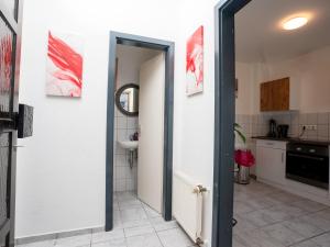 a bathroom with an open door to a kitchen at SR24 - Space in Herten West in Herten