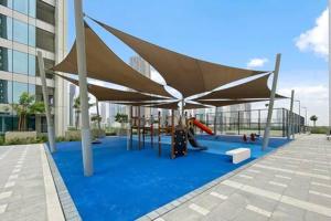 a playground with a canopy in a building at Silkhaus luxurious 1BDR in new tower with pool & gym in Dubai