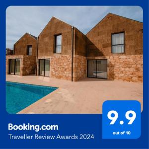 a brick house with a pool in front of it at Chalês - Maria Alva in Marialva