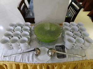 a group of cups and spoons on a table at GRAND DARUSSALAM HOTEL in Medan