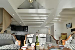 カンカルにあるLOstra 2 - Appartement avec mezzanineの椅子2脚、テーブル、ワイン1本が備わる客室です。
