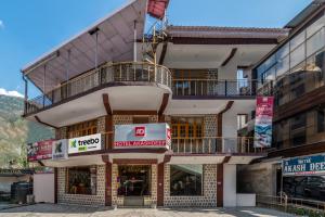 a building with a balcony on top of it at Treebo Trend Akashdeep in Dharamshala