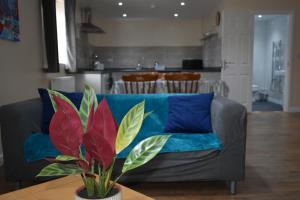 a living room with a couch and a table at 4 Woodyard Cottages, 2 Bedroom with free parking. in Long Sutton