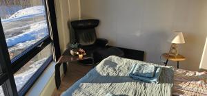 a room with a window with a chair and a couch at Panorama view in Stranda +4 photos