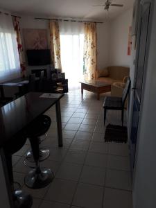 a living room with a table and a couch at 1 bedroom in Regina Gardes 2 in Paphos City