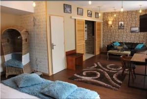 a living room with a couch and a table and a living room at Logis Hôtel & Restaurant - Le Mouton Blanc in Cambrai