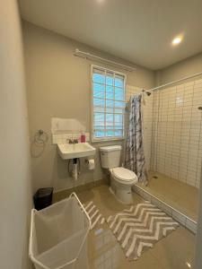 a bathroom with a toilet and a sink at A modern townhouse at Farm in Georgetown