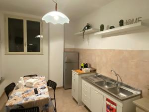 a small kitchen with a sink and a table at La dimora nonna Eugy in Polignano a Mare +20 photos