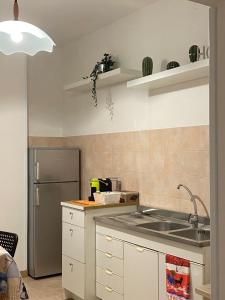 a kitchen with a sink and a refrigerator at La dimora nonna Eugy in Polignano a Mare