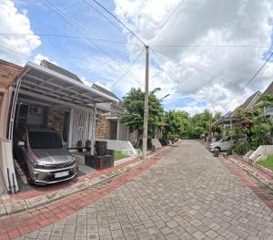 a car parked outside of a house at GKR J8 Homestay Jogja in Pedes