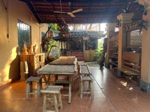 a room with a wooden table and some stools at Lagom Village (Glamping Site) in Hanoi