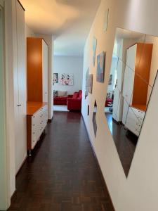 - un couloir avec un salon doté d'un canapé rouge dans l'établissement Look giovane per una casa vista lago, à Côme