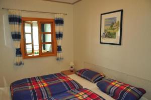 una camera da letto con un letto con due cuscini e una finestra di RES 406 - Apartment Meeresliebe - Seeblick a Scharbeutz