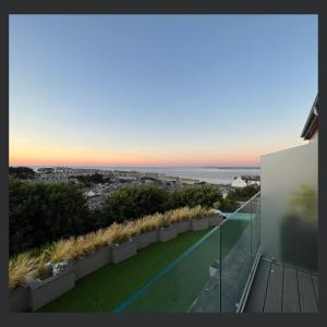 a view of the ocean from the balcony of a house at Uno St Ives - Luxury Serviced Accommodation in St Ives