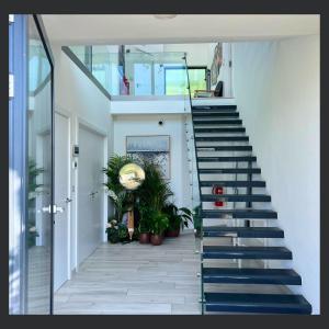 a staircase with blue treads in a house at Uno St Ives - Luxury Serviced Accommodation in St Ives