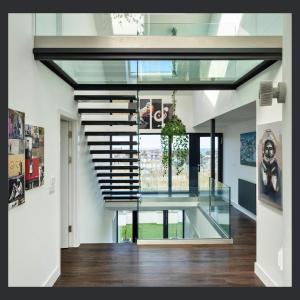 a staircase in a house with a glass ceiling at Uno St Ives - Luxury Serviced Accommodation in St Ives