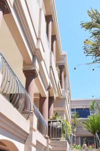 a building with columns and plants on the side of it at 134 On Ocean View in Amanzimtoti