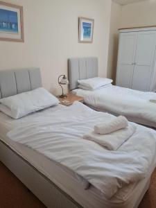 two beds sitting next to each other in a room at Chymoresk - Self Catering Holiday Cottage Hayle St Ives Bay in Hayle