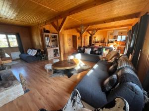 a living room with a couch and a table at Chalet l'Aigle bleu in Uvernet