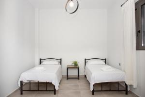 A bed or beds in a room at Christina Apartment