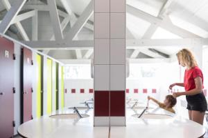 a woman and a child in a bathroom with sinks at Camping Municipal Tindio in Arzon