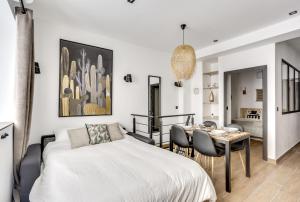 sypialnia z łóżkiem, stołem i krzesłami w obiekcie 149 Suite Christophe - Superbe Appartement à Paris w Paryżu