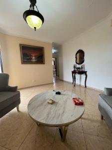 a living room with a table and a couch at Comfortable and cute in Santo Domingo