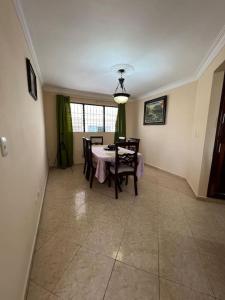 a dining room with a table and chairs in it at Comfortable and cute in Santo Domingo