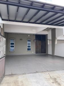 a large empty garage with a metal roof at C & L Home 002 in Kluang