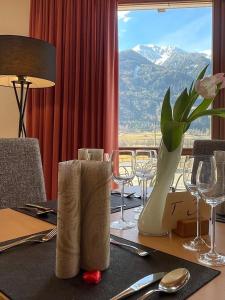 a dining room table with a view of a mountain at Hotel Larch in Campo di Trens