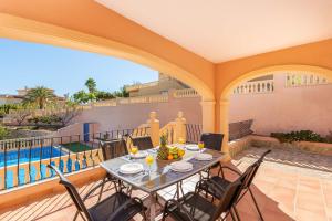 a patio with a table and chairs on a balcony at Villa Amanda - PlusHolidays in Calpe