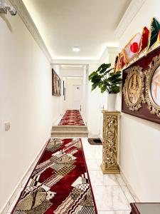 a hallway with a red rug on the floor at Afnan Cairo Airport in Cairo