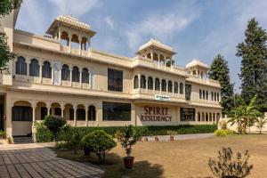 een groot gebouw met een binnenplaats ervoor bij Treebo Trend Spirit Residency in Udaipur