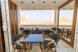 a room with chairs and tables andramids in the background at White Pyramids inn in Cairo