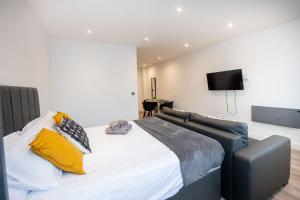 a bedroom with a large bed with yellow pillows at Studio Apartment in Liverpool City Centre in Liverpool