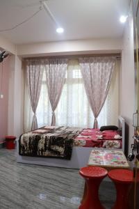 a bedroom with a bed and a large window at Apurna Guest House Dawki in Dawki