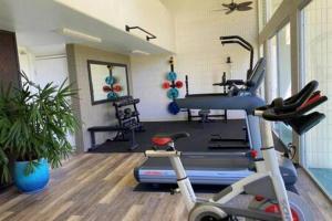 a gym with a treadmill and a exercise bike at Beautiful Beachfront Condo in Laie