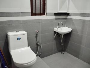 a bathroom with a toilet and a sink at Apurna Guest House Dawki in Dawki