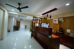 a lobby of a hospital with a ceiling fan at Happy Nest Guest Home in Kurmannapalem