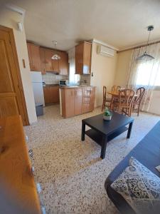 uma sala de estar com uma mesa e uma cozinha em Maison santa pola em Santa Pola