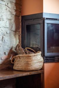 a basket sitting on a table next to a microwave at Ca L'Estamenya in Perafita