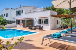una villa con piscina frente a una casa en Sa Lluna Galdana, en Cala Galdana