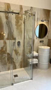 a bathroom with a shower and a sink at PALAZZO CHINIAL in Torre del Greco