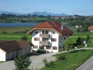 a large white house with a red roof at See Cafe Toni in Rimsting