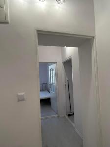 a hallway in a house with a hallway leading into a room at Apartament 2 pokoje, Przemyśl, 1 piętro in Przemyśl