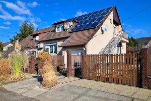 a house with solar panels on the roof at Vár-Lak Apartman in Sümeg