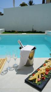 a table with a plate of food and two wine glasses at Diana Palace Hotel Zakynthos in Argassi